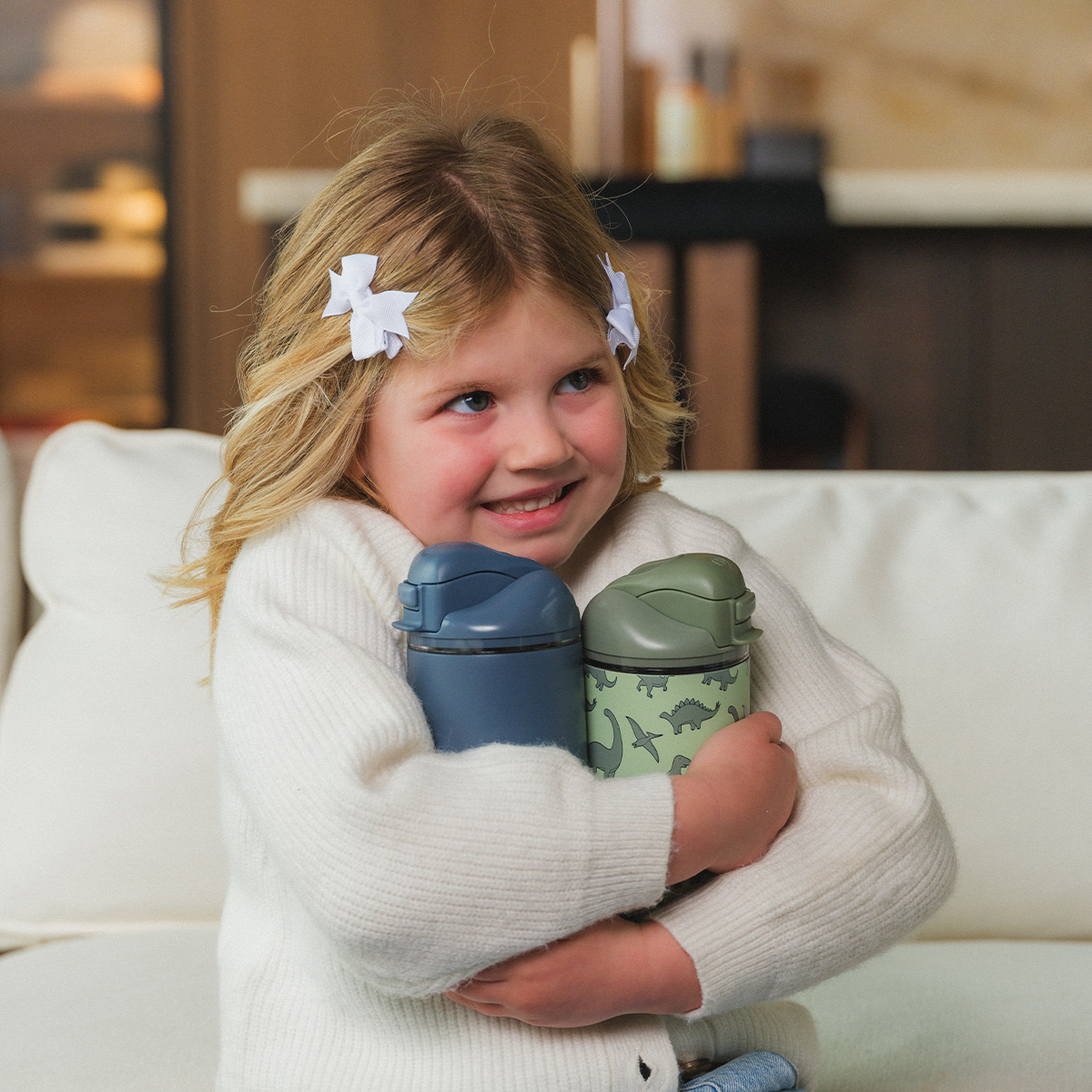 Girl Holding 14oz Cascade and Dinoasur HydroJug Ease2o